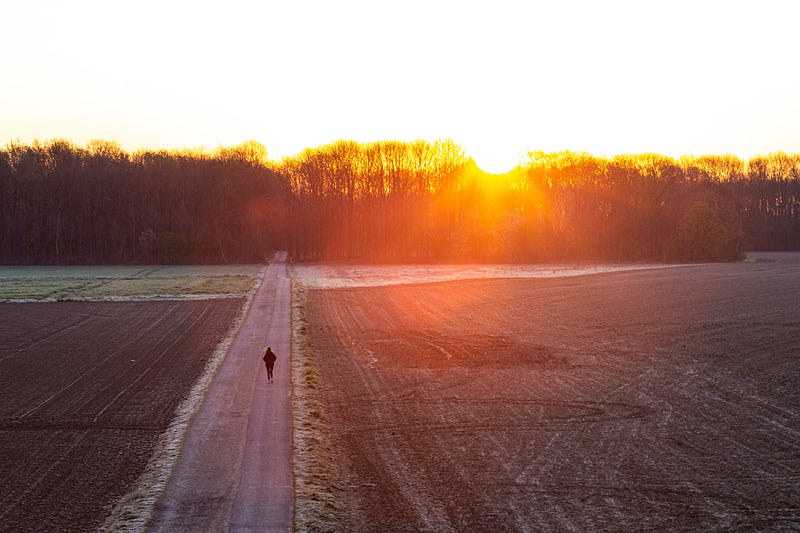 A runner stretching before the challenge of cross country